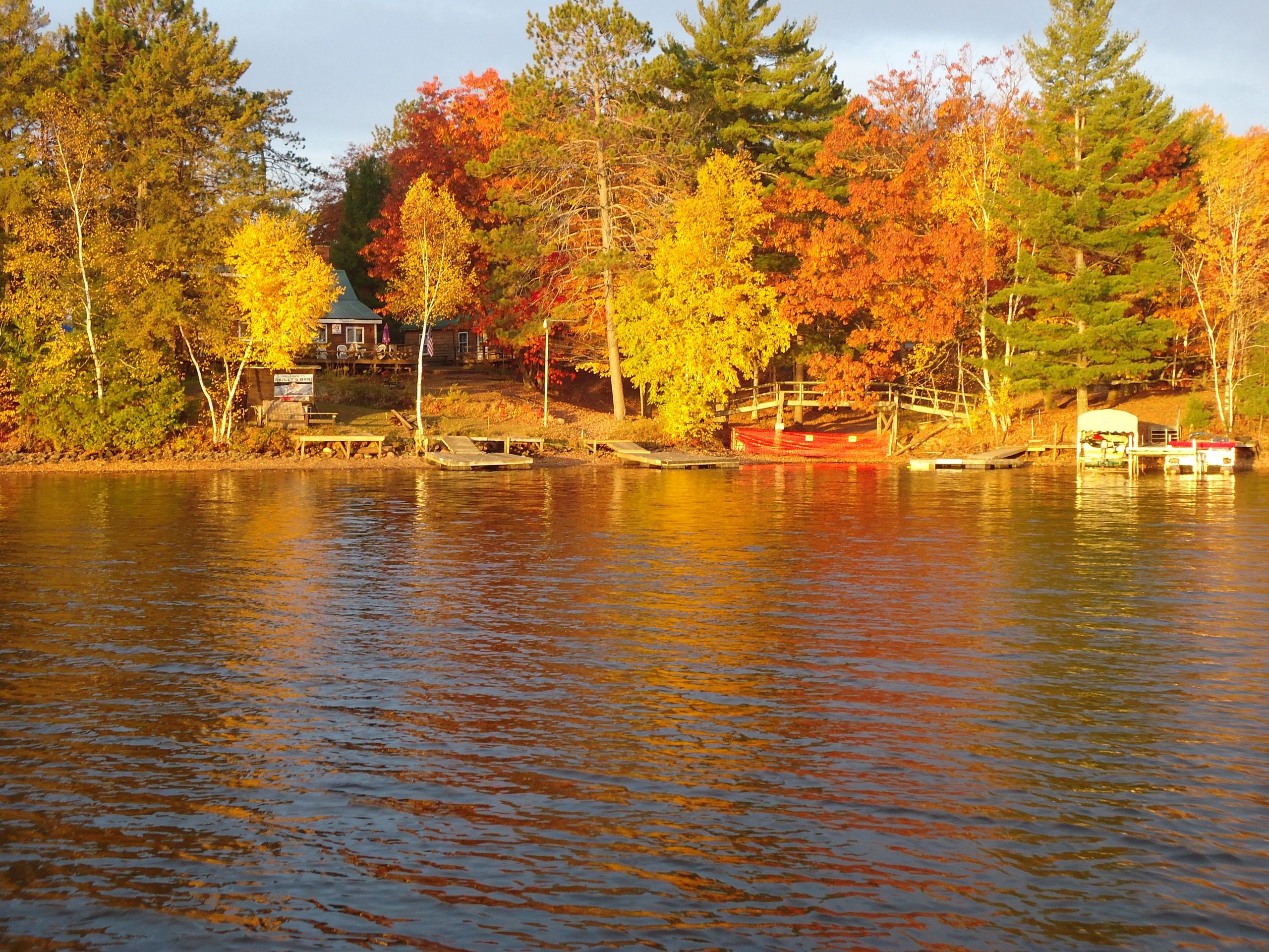 Lakeside cottage in autumn